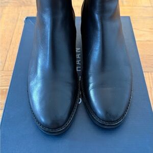 Cole Haan Chelsea boots in black.